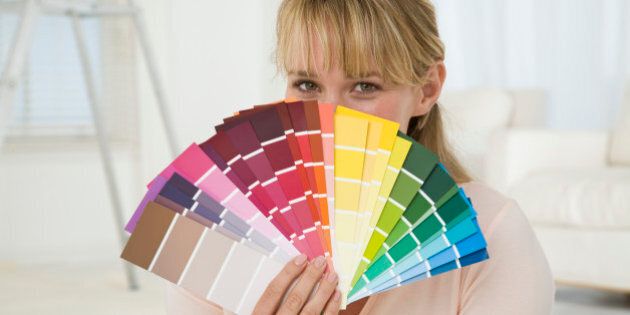 Woman holding paint swatches
