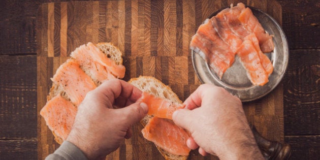 Cooking sandwiches with salmon on the wooden table top view