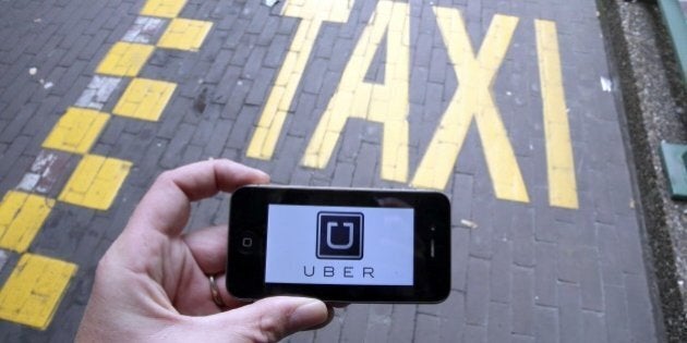 The logo of Uber car service app is seen on a smart phone during a protest by Brussels taxi drivers against the taxi-app Uber, on September 13, 2015, in Brussels. AFP PHOTO / BELGA / NICOLAS MAETERLINCK =BELGIUM OUT= (Photo credit should read NICOLAS MAETERLINCK/AFP/Getty Images)