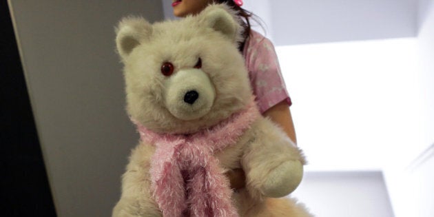 A member of the group Sa.weet carries a teddy bear backstage while waiting to perform at the Portuguese K-Pop festival in Lisbon's Orient Museum Saturday, Aug. 8, 2015. During the festival, Portuguese young artists perform Korean pop songs competing for a chance to participate in a festival later in the year in South Korea. (AP Photo/Armando Franca)