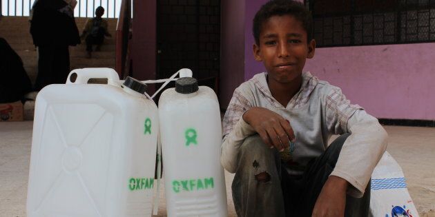 10-year-old Noran with Oxfam hygiene kits as part of a cholera response in Yemen.