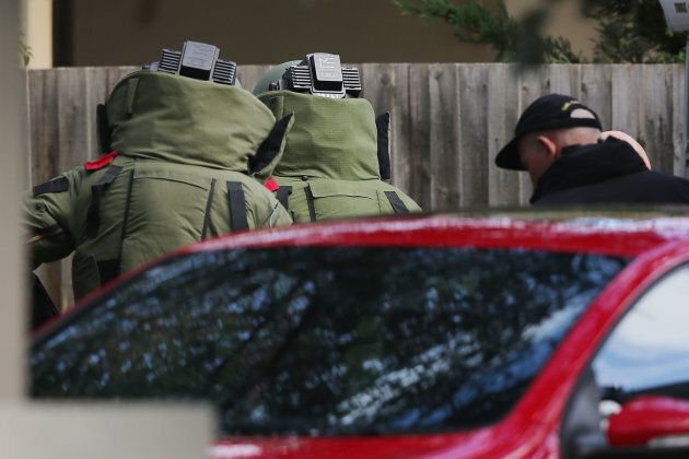 Explosives device detectors are sent down the driveway outside service apartments on June 6, 2017 in Melbourne, Australia. Police are treating an incident where an armed man shot and killed a man and held a woman hostage as an act of terror.