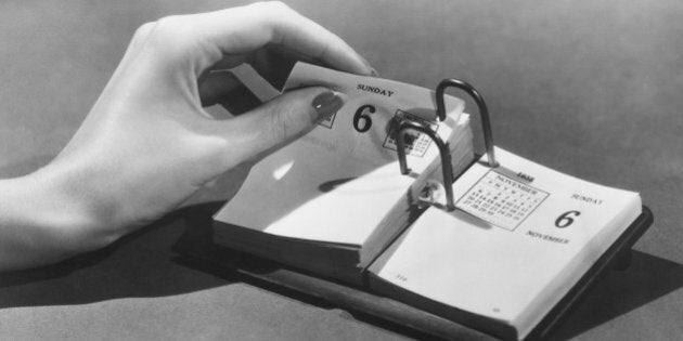 Woman turning page in date book