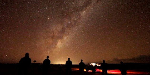 In this May 28, 2013 photo, tourists stand and gaze at the milky-way near Broken Hill, 1,160 kilometers (720 miles) from Sydney, Australia, during a seven-day, 3,000-kilometer (1,900-mile) journey across the Outback. (AP Photo/Rob Griffith)