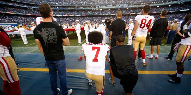 SAN DIEGO, CA - SEPTEMBER 1: Eric Reid #35 and Colin Kaepernick #7 of the San Francisco 49ers kneel on the sideline during the anthem, as free agent Nate Boyer stands, prior to the game against the San Diego Chargers at Qualcomm Stadium on September 1, 2016 in San Diego, California. The 49ers defeated the Chargers 31-21. (Photo by Michael Zagaris/San Francisco 49ers/Getty Images)
