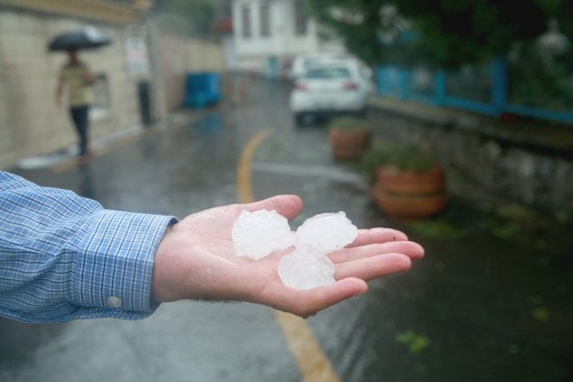 Hail the size of golf balls damaged the aircraft's windscreen.