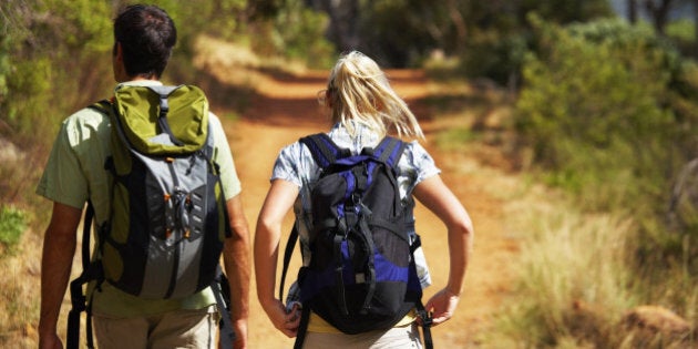 Rear view of a couple backpacking