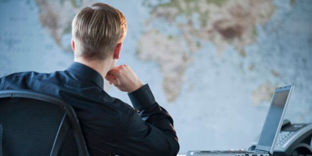 Businessman looking at world map