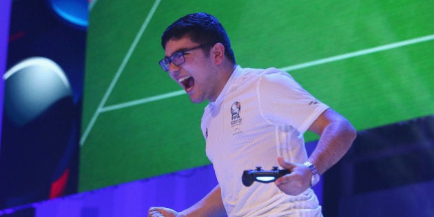 NEW YORK, NY - MARCH 22: Mohamad Al-Bacha of Denmark celebrates after defeating Ivan Lapanje of Sweden during the FIFA Interactive World Cup Semi-Finals at the Apollo Theater New York on March 22, 2016 in New York City. (Photo by Alexander Hassenstein - FIFA/FIFA via Getty Images)