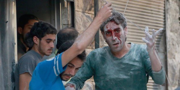 A wounded man is seen after airstrikes near Aleppo, Syria on Tuesday.