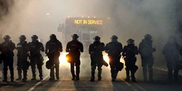 Police officers wearing riot gear block a road during protests after police fatally shot Keith Lamont Scott in the parking lot of an apartment complex in Charlotte North Carolina US September 20 2016