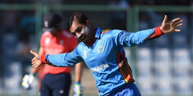 Afghanistan's Samiullah Shenwari celebrates the wicket of England's Jos Buttler during the World T20 cricket tournament match between England and Afghanistan at The Feroz Shah Kolta Cricket Stadium in New Delhi on March 23, 2016. / AFP / PRAKASH SINGH (Photo credit should read PRAKASH SINGH/AFP/Getty Images)