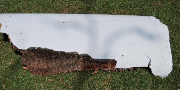 The curved piece of debris which may be part of the missing Malaysia Airlines Flight MH370, in Wartburg, 37km (22 miles) out of Pietermaritzburg, South Africa, Monday, March 7, 2016. South African teenager Liam Lotter vacationing with his family in Mozambique on Dec. 30, may have found part of a wing from the missing plane, while he was strolling on the beach. Liam struggled to lift the debris from the beach and carried it back home to South Africa before discovering it might be from the lost plane, but now aviation experts plan to examine the plane fragment. The Malaysia Airlines Boeing 777 jet vanished with 239 people on board while flying from Kuala Lumpur to Beijing on March 8, 2014. (Candace Lotter via AP)