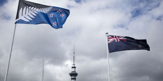 The existing New Zealand flag, right, flies alongside an alternative flag design as the Sky Tower, center, stands in Auckland, New Zealand, on Wednesday, March 2, 2016. New Zealanders will vote in a change-of-flag referendum from March 3-24 on whether to adopt a new design. Photographer: Brendon O'Hagan/Bloomberg via Getty Images