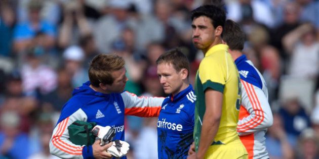 MANCHESTER, ENGLAND - SEPTEMBER 13: England batsman Eoin Morgan is looked at by the physio after being hit on the helmet by a ball from Mitchell Starc (r) and retires hurt during the 5th Royal London One-Day International match between England and Australia at Old Trafford on September 13, 2015 in Manchester, United Kingdom. (Photo by Stu Forster/Getty Images)