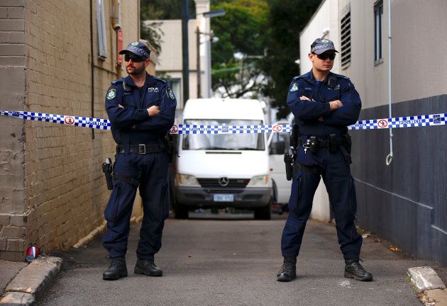 Police officers block a small alley where police vans are parked at a home being searched after Australian counter-terrorism police arrested four people in raids late on Saturday across several Sydney suburbs in Australia, July 30, 2017. REUTERS/David Gray