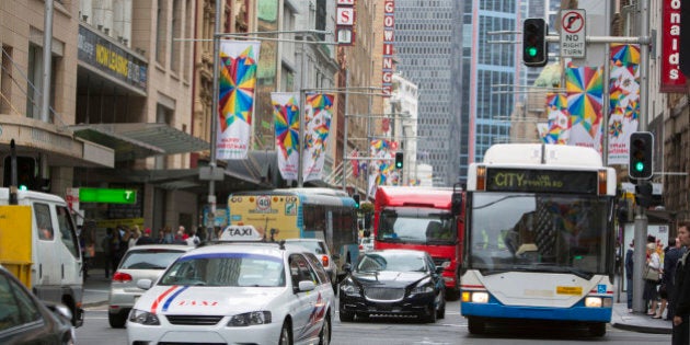 Traffic in Sydney Australia including a taxi and a bus at the intersection of George and King Streets