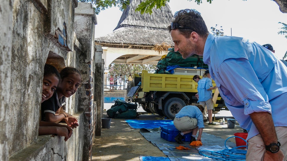 AUSMAT Australian doctor, Alex Swann, chats to some of the kids as he awaits riders at the finish line. Baucau, Timor-Leste.