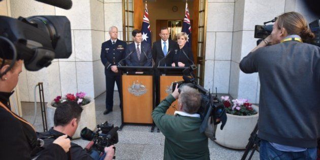Australian Prime Minister Tony Abbott, Chief of the Australian Defence Force Mark Binskin (L), Defence Minister Kevin Andrews (2nd-L) listen to Foreign Minister Julie Bishop (R) addressing the media during a press conference at Parliament House in Canberra on September 9, 2015. Australia will take an extra 12,000 refugees in response to the humanitarian crisis in the Middle East, Abbott said, confirming Canberra would join coalition air strikes against Islamic State group in Syria. AFP PHOTO / MARK GRAHAM (Photo credit should read MARK GRAHAM/AFP/Getty Images)
