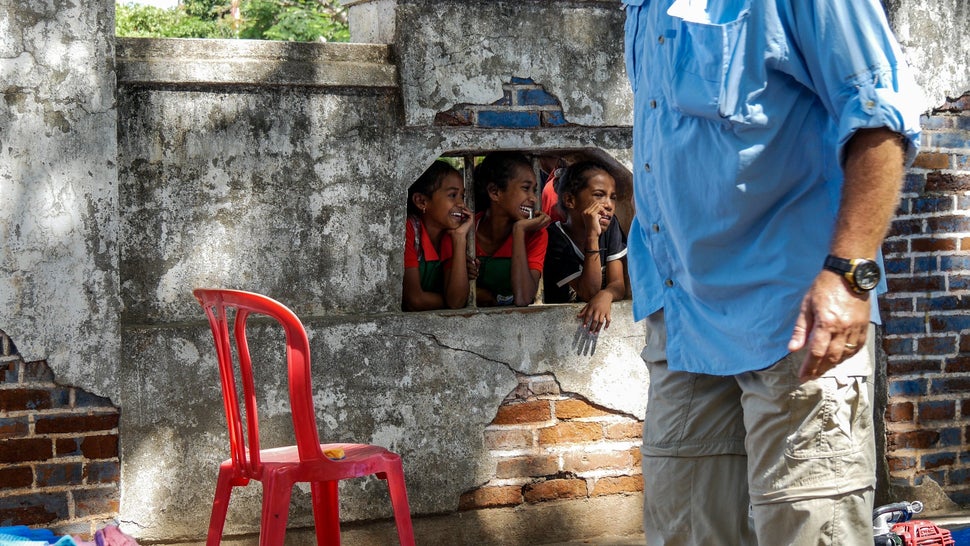 These girls peak through to see what the AUSMAT medical team get up to. Baucau, Timor-Leste.