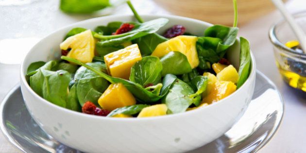 Mango and pineapple with spinach and dried cranberries salad