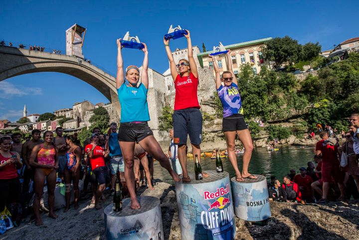 Cesilie Carlton of the USA, Lysanne Richard of Canada and Rhiannan Iffland of Australia celebrate on the podium, Stari Most during the seventh stop of the Red Bull Cliff Diving World Series in Mostar, Bosnia & Herzegovina on September 24, 2016.