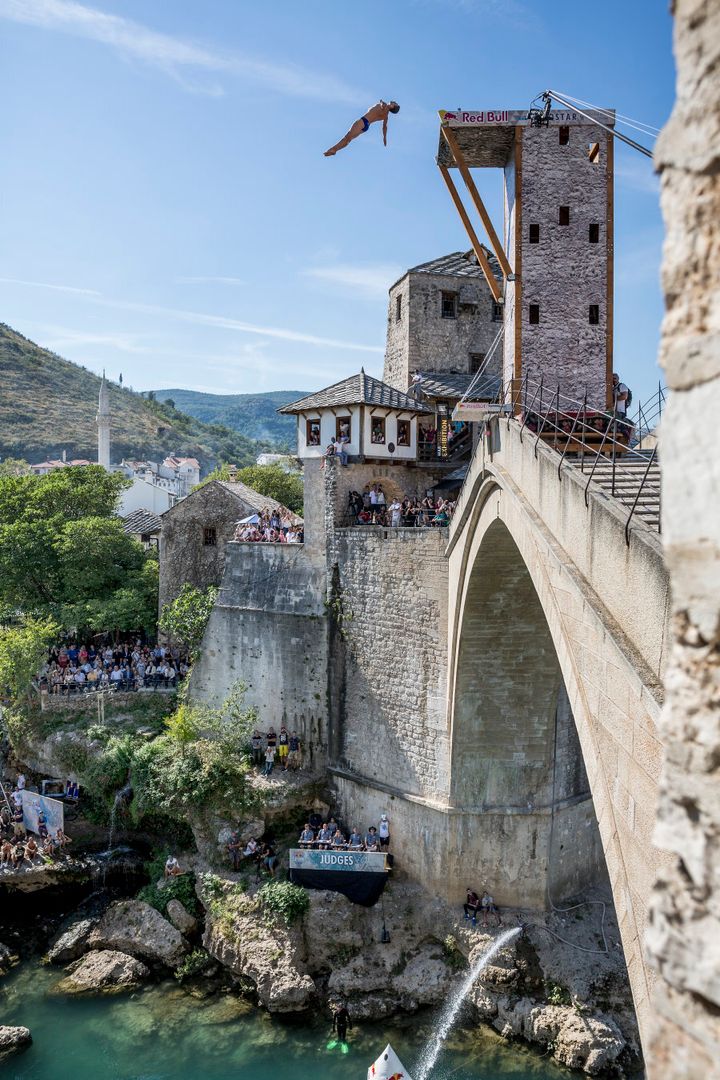 Michal Navratil from Czech Republic cliff diving from the picturesque Stari Most bridge in Mostar, Bosnia and Herzegovina.
