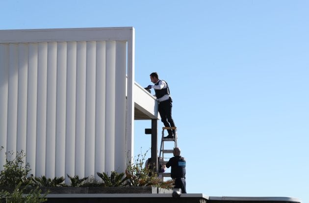 Police search the gutters of John Ibrahim's Dover Heights home in Sydney