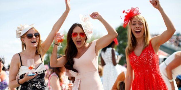 ASCOT, UK. 18 JUNE: Racegoers celebrating after winning a bet on a race on Ladies Day of Royal Ascot at Ascot racecourse in Berkshire, England on June 18, 2015. The 5 day showcase event, which is one of the highlights of the racing calendar, has been held at the famous Berkshire course since 1711 and tradition is a hallmark of the meeting. Top hats and tails remain compulsory in parts of the course. (Photo by Tolga Akmen/Anadolu Agency/Getty Images)