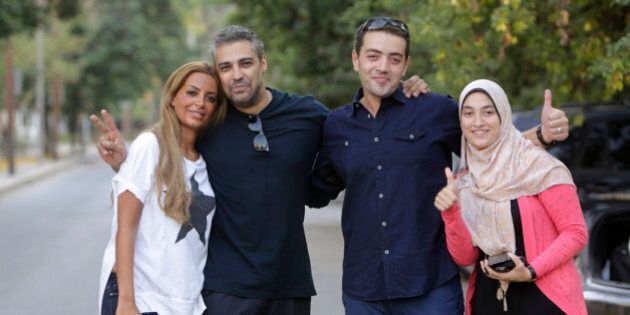 Canadian Al-Jazeera English journalist Mohamed Fahmy second left, and his Egyptian colleague Baher Mohammed, celebrate with their wives after being released from Torah prison in Cairo, Egypt, Wednesday, Sept. 23, 2015. Fahmy and his colleague Baher, were among a group of 100 people pardoned by Egyptian President Abdel-Fattah el-Sissi on the eve of the major Muslim holiday of Eid al-Adha. The pardon also comes a day before the Egyptian leader is to travel to New York to attend the United Nations General Assembly. (AP Photo/Amr Nabil)