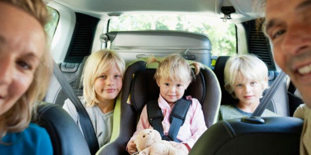Family in car, smiling at camera
