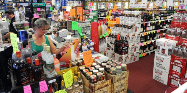 AURORA, CO - AUGUST 13: Stacey Benson, an employee at the Bottle Barn, works at the store on August 13, 2015, in Aurora, Colorado. A Safeway grocery store, formerly operated at the Aurora Highlands Shopping Center, closed earlier this year leaving a vacancy that the Safeway-Albertson holding company doesn't intend to lease to a new tenant. Owners of the shopping center are working on a solution to revitalize the strip mall. (Photo by Anya Semenoff/The Denver Post via Getty Images)