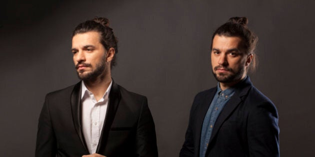 Two handsome young men with a beard and long hair in a bun