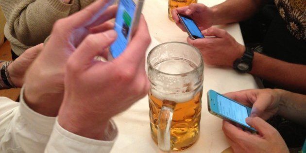 Oktoberfest Bavaria Germany Smartphone Communication and Stein of Beer as a Group of People