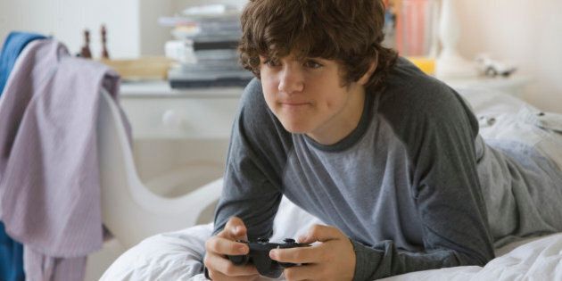 Teenaged boy playing video games