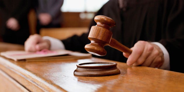 Judge holding gavel in courtroom