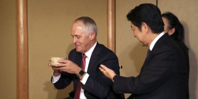 Australian Prime Minister Malcolm Turnbull (L) and Japanese Prime Minister Shinzo Abe (R) attend a tea ceremony hosted by Sen Soshitsu (not in picture), the Grand Tea Master at the Tokyo headquarters of the Urasenke school of tea ceremony in Tokyo on December 18, 2015. AFP PHOTO / POOL / Eugene Hoshiko / AFP / POOL / EUGENE HOSHIKO (Photo credit should read EUGENE HOSHIKO/AFP/Getty Images)