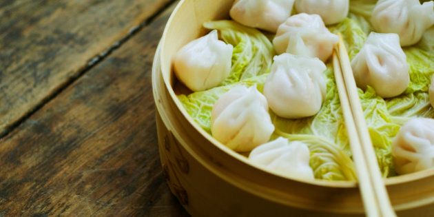 Asian dumpling in steamer with cabbage