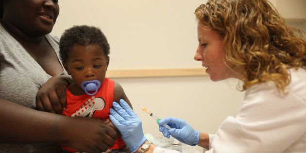 India Ampah holds her son, Keon Lockhart, 12 months old, as pediatrician Amanda Porro M.D. administers a measles vaccination during a visit to the Miami Children's Hospital on June 02, 2014 in Miami, Florida.
