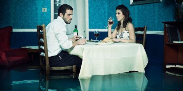 Couple dinning in flooded room