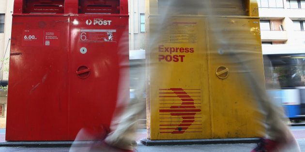 SYDNEY, AUSTRALIA - MAY 07: A man scuttles past a Post Office Box outside the Darlinghurst Post Office on May 7, 2014 in Sydney, Australia. Australia Post is considering a user-pay mail delivery model as letter operations saw a AUD $218 million loss last year. (Photo by Don Arnold/Getty Images)