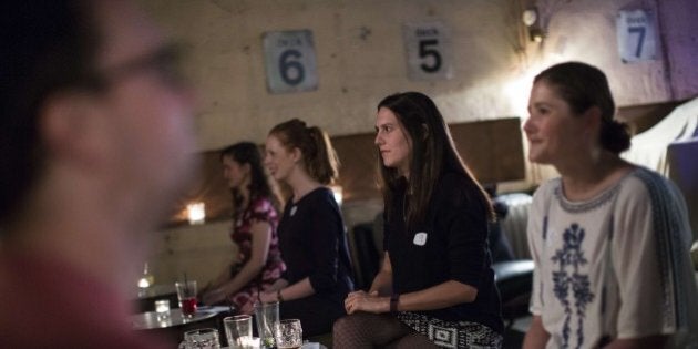 TO GO WITH AFP STORY BY EDOUARD GUIHAIRE Men and women take part in an evening of silent speed dating in a bar in east London on September 23, 2015. Candles and languid electro-jazz set the scene for a romantic rendezvous at a north London bar, where participants begin the evening with a warm-up of non-verbal flirting games but the couple sitting face-to-face can use only their eyes to beguile. The 90-second silent date is the latest attempt by Londoners to reinvent the city's intoxicating world of nightclubs, bars and fleeting liaisons. AFP PHOTO / JACK TAYLOR (Photo credit should read JACK TAYLOR/AFP/Getty Images)