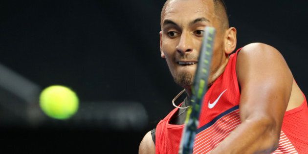 Nick Kyrgios of Australia makes a backhand return to Pablo Carreno Busta of Spain during their first round match at the Australian Open tennis championships in Melbourne, Australia, Monday, Jan. 18, 2016.(AP Photo/Rick Rycroft)