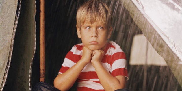 Sad Young Boy Camping in the Rain