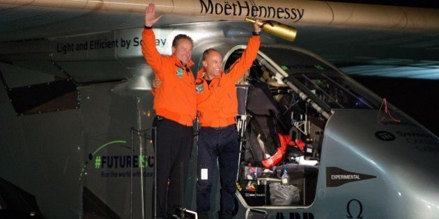 Swiss adventurer Bertrand Piccard (R) and Andre Borschberg (L) wave to the crowd after landing Solar Impulse 2 at Moffett Field in Mountain View, California on April 23, 2016. Solar Impulse 2, an experimental plane flying around the world without consuming a drop of fuel, landed in California, one leg closer to completing its trailblazing trip. / AFP / Josh Edelson (Photo credit should read JOSH EDELSON/AFP/Getty Images)
