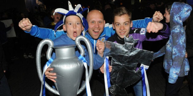 LEICESTER, ENGLAND - MAY 02: Leicester City Fans celebrate their team becoming Premier League champions outside King Power Staduim on May 2nd , 2016 in Leicester, United Kingdom. (Photo by Plumb Images/Leicester City FC via Getty Images)