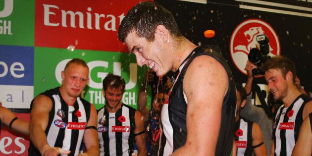 MELBOURNE, AUSTRALIA - APRIL 25: Mason Cox of the Magpies is showered with drink after winning his first game with the club during the round five AFL match between the Collingwood Magpies and the Essendon Bombers at Melbourne Cricket Ground on April 25, 2016 in Melbourne, Australia. (Photo by Michael Dodge/Getty Images)