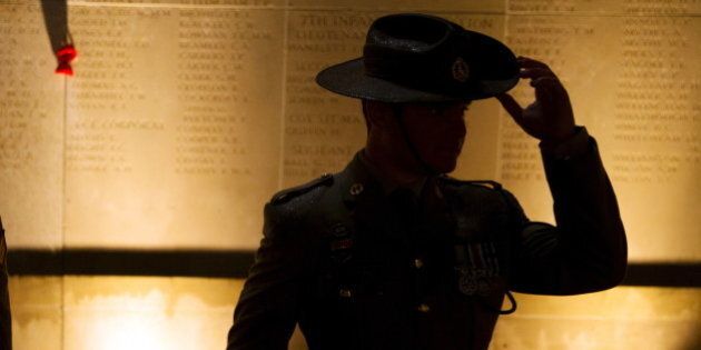 An Australian army soldier attends the dawn service to mark the 100th anniversary of ANZAC (Australian and New Zealand Army Corps) Day at the Australian National Memorial in Villers-Bretonneux, in northern France, April 25, 2015. The Gallipoli campaign has resonated through generations, which have mourned the thousands of soldiers from the ANZAC cut down by machinegun and artillery fire as they struggled ashore on a narrow beach. The fighting would eventually claim more than 130,000 lives, 87,000 of them on the side of the Ottoman Turks, who were allied with imperial Germany in World War One. REUTERS/Philippe Wojazer