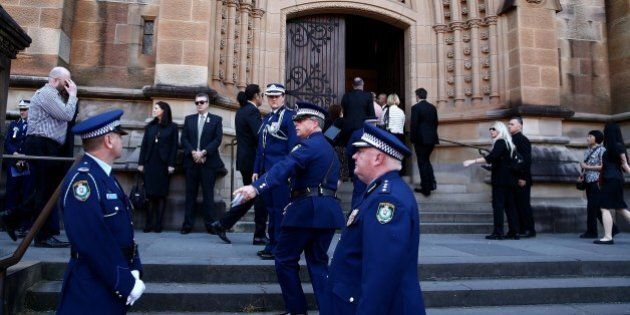 SYDNEY, AUSTRALIA - OCTOBER 17: People arrive for a funeral service for Curtis Cheng at St Mary's Cathedral October 17, 2015 in Sydney, Australia. Police employee, Curtis Cheng, was shot outside the NSW police headquarters in Parramatta two weeks ago by an Iranian born Australian. Australian Prime Minister Malcolm Turnbull has called the murder an 'act of terrorism.' (Photo by Tim Hunter.-Pool/Getty Images)