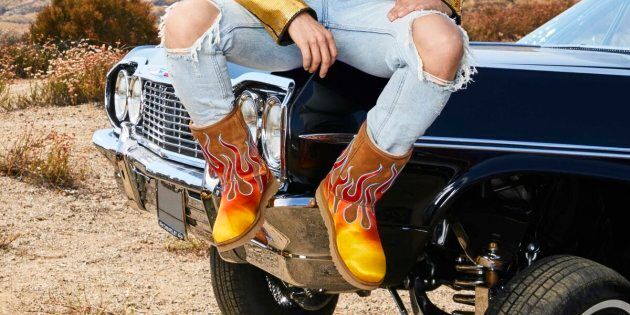 Jeremy Scott models a pair of boots from his collaboration with Ugg.